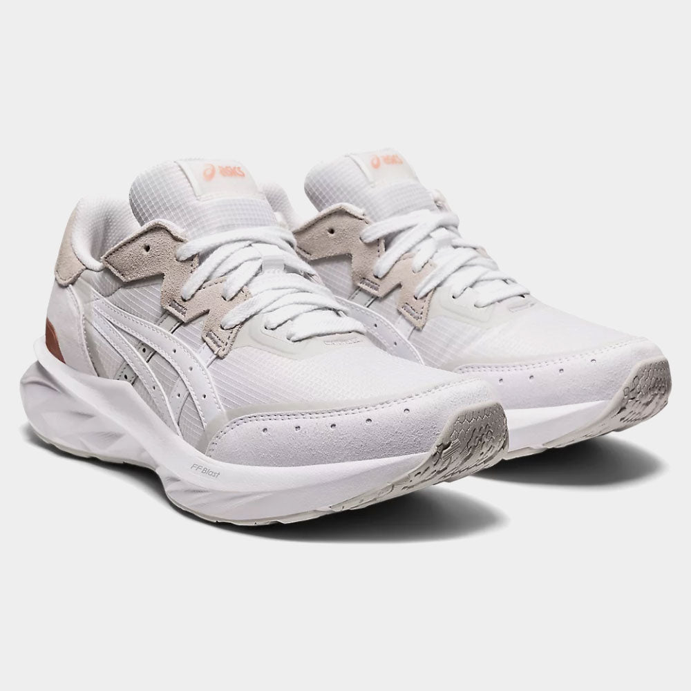 White sneaker with brown accents on a white background